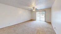 Located at 1105 Anthrop Dr in West Lafayette, Indiana, this single-story, 4-bedroom, 3-bathroom home offers a practical and well-organized layout across a comfortable footprint. The living room is generously sized, featuring soft carpeting, a ceiling fan, a textured ceiling, and a sliding glass door that fills the space with natural light and provides access to the outdoors. Adjacent to the living room, the dining area connects seamlessly to the kitchen, which is a standout feature of the home. The kitchen is equipped with white cabinetry, granite-look countertops, white appliances including a range and microwave, a peninsula with a sink, and wood-look vinyl flooring that extends throughout the main living and kitchen areas. A dedicated pantry and an in-unit laundry room with utility access add convenience. The four bedrooms are carpeted and well-lit, with most featuring window blinds that allow for natural light. The primary bedroom offers a notably spacious feel. The three bathrooms include a full bath with a tub/shower combo and wood-look flooring, as well as a larger bathroom featuring an extended vanity with ample cabinet storage and a wide mirror. Six closets throughout the home ensure generous storage. The textured ceilings are consistent throughout, contributing to the home's classic character.
