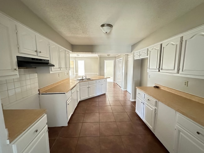 Building Photo - Grand 4BR/2BA Near Southwind | 2,438 Sq Ft, Stone Fireplace, Soaking Tub & 2-Car Garage