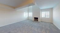 Located at 150 E Schiller St in Elmhurst, Illinois, this two-floor residence offers a well-organized layout with a neutral, light color palette throughout. The living areas are finished with plush carpeting and warm beige tones, creating a comfortable and cohesive atmosphere across both levels. A ceiling fan with pull-chain controls is installed in one of the upper rooms, which also benefits from multiple windows that invite natural light and offer outdoor views. A standout feature is the sliding glass door that opens onto a private balcony, providing an open-air retreat with expansive views of the surrounding area. Carpeted bedrooms are generously proportioned, with at least one featuring a built-in closet organizer system, offering practical storage solutions. The upper level is connected by a carpeted hallway and staircase with gold-toned hardware accents on the doors. The bathrooms are cleanly finished with white cabinetry, solid-surface countertops, large mirrors with illuminated vanity lighting, and light wood-look flooring. One bathroom includes a tiled tub-and-shower combination, while others are appointed as full or partial baths. The overall design is clean, functional, and move-in ready.
