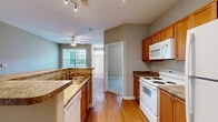 Located at 5000 Mountain Springs Dr in Nashville, TN, this well-appointed 2-bedroom, 2-bathroom single-story home offers a comfortable and functional layout. Warm hardwood flooring flows throughout the main living areas, lending a cohesive and inviting feel from the moment you enter.

The open-concept kitchen and living area serves as the heart of the home. The galley-style kitchen is equipped with rich wood cabinetry, granite-style countertops, a breakfast bar peninsula, and a full suite of white appliances including a range, microwave, refrigerator, and dishwasher. Track lighting and a ceiling fan with light kit keep the space bright and comfortable. Large windows in the living area allow abundant natural light and views of the surrounding greenery.

Both bedrooms are generously sized, featuring ceiling fans, hardwood or plush carpet flooring, and windows that bring in natural light. The spacious primary bedroom includes dual windows offering outdoor views and dedicated closet space. Each bedroom is served by its own full bathroom, both finished with wood-toned vanities, granite-style countertops, and tub-shower combinations with tiled surrounds. A hallway connects the rooms efficiently, and two closets provide practical storage throughout the home.