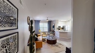 Located at 700 N Coronado St in Chandler, Arizona, this single-floor residence offers a thoughtfully designed layout with a cohesive, modern-bohemian aesthetic throughout. The open-concept living area is bright and inviting, featuring wood-look flooring, ceiling fans, and large windows dressed with floor-to-ceiling drape panels that allow for ample natural light. Built-in shelving adds functional character to the living space, while the seamless flow into the kitchen and dining areas enhances the overall sense of openness. The kitchen is well-equipped with stainless steel appliances, including a refrigerator, range, microwave, and dishwasher, complemented by white cabinetry, a tile backsplash, and light countertops. A peninsula with a undermount sink provides additional prep space and casual seating options. The adjacent dining nook features a pendant light fixture, a window with natural light, and built-in shelving. Both bedrooms are carpeted and generously sized, each with a ceiling fan and windows. The primary bedroom includes an en-suite bathroom with a sliding glass walk-in shower, a vanity with ample storage, and wood-look flooring. The secondary bathroom features a full soaking tub and shower combination. The residence presents a well-balanced combination of comfort, style, and practical design.