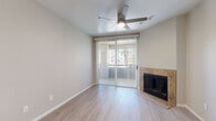 Located at 411 N Kyrene Rd in Chandler, Arizona, this single-floor, one-bedroom, two-bathroom residence offers a thoughtfully efficient layout across a well-utilized footprint. The living room serves as the heart of the home, featuring light-toned wood-style flooring, a ceiling fan, a sliding glass door that invites natural light and outdoor views, and a standout tile-surround fireplace that adds warmth and character to the space. The kitchen is well-appointed with crisp white cabinetry, light stone-look countertops, and a full suite of stainless steel appliances including a gas range, dishwasher, microwave, and refrigerator — all set atop matching light-toned flooring. The bedroom is carpeted for comfort and also features a ceiling fan and sliding glass door access, providing natural light and outdoor connectivity. Two bathrooms serve the residence: one features a vanity with white cabinetry, stone-look countertops, and ample storage, while the second includes a full tub-shower combination. A dedicated closet and hallway complete the layout. Throughout, the unit maintains a neutral, contemporary palette of soft grays and whites, creating a clean, cohesive ambiance ideal for everyday living in the Chandler, AZ area.