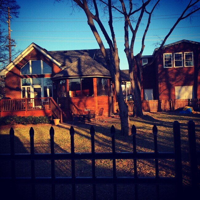 Back of house showing garage, porch, deck, and large fenced in yard - 1001 14th Ave S