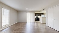 Located at 2280 N Tara Cir in Wichita, Kansas, this single-story residence offers a clean, modern aesthetic with a cohesive neutral color palette throughout. The open-concept living and dining area is a standout feature, showcasing durable wood-look flooring that flows seamlessly through the main living spaces. A striking brick-accent fireplace anchors one wall, complemented by large windows that invite abundant natural light. Sliding glass doors with vertical blinds provide access to the outdoors, enhancing the sense of openness.

The kitchen is efficiently designed with dark espresso cabinetry, light stone-look countertops, tile flooring, and a full suite of appliances including a refrigerator, range, microwave, and dishwasher. A peninsula counter connects the kitchen to the living area, creating a practical and social layout.

The bedroom is generously proportioned, featuring wood-look flooring, corner windows for natural light, and mirrored sliding closet doors. The bathrooms are finished with dark vanity cabinetry, granite-style countertops, framed mirrors, and tile flooring, offering a polished and functional feel. The entry foyer provides a welcoming transition into the main living space, completing this well-maintained and thoughtfully designed home.