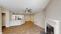 This single-story residence in Wesley Park, Norcross, GA offers a well-designed open-concept layout with distinct functional zones throughout. The living area is anchored by a classic fireplace with a white mantel surround and is finished with wood-look flooring and a textured ceiling. A ceiling fan with integrated lighting provides airflow, while neutral wall tones create a cohesive, understated palette. A bright nook area features a glass exterior door and large windows fitted with blinds, allowing ample natural light to filter in.

The kitchen is a notable feature, showcasing white cabinetry, a subway tile backsplash, and a sweeping granite-topped peninsula with an undermount sink—ideal for both meal preparation and casual dining. Stainless steel appliances, including a refrigerator and electric range, complete the space, which flows seamlessly into the main living area.

Bedrooms are carpeted for comfort, with one featuring a walk-in closet equipped with built-in shelving. Additional bedrooms offer natural light through windows with blinds. A dedicated laundry area accommodates a full-size washer and dryer. The bathroom includes a soaking tub with tiled surround and a wall-mounted mirror.