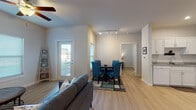 Located along SH-123 in San Marcos, Texas, this single-story residence offers a clean, modern layout designed for comfortable everyday living. The open-concept living and dining area is bright and welcoming, featuring light wood-style flooring, neutral white walls, and ceiling fans throughout. Multiple windows allow natural light to fill the space, while a glass door provides direct outdoor access. Track lighting over the dining area adds a functional, contemporary touch.

The kitchen is generously sized and well-equipped, showcasing white shaker-style cabinetry, granite-look countertops, a full suite of white appliances including a range and refrigerator, and a dishwasher. Recessed lighting illuminates the workspace, making it both practical and visually open.

The bedroom is a comfortable retreat, featuring light wood flooring, a ceiling fan, and a well-sized window that brings in natural light. A closet provides ample storage, and the room's neutral palette offers flexibility for personalization.

The bathroom is finished with a white vanity, tile flooring, and a shower-tub combination, offering a clean and functional design. Throughout the residence, consistent flooring, neutral tones, and thoughtful finishes create a cohesive and inviting atmosphere suited for a variety of lifestyles.