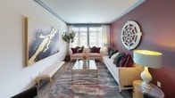 Located on Providence Road in Charlotte's desirable 28211 corridor, this single-floor residence showcases a thoughtfully curated interior that balances bold design choices with functional living. The open layout, visible in the 3D floor plan, connects the key living areas seamlessly, creating a cohesive flow throughout the space.

The living room is a standout, featuring a dramatic deep burgundy accent wall adorned with a decorative medallion, contrasted by soft neutral tones on the remaining walls. Large windows invite natural light, while hardwood-style flooring, crown molding, and bold large-scale artwork contribute to the room's refined character. Seating is arranged to encourage both conversation and comfort.

The kitchen is well-appointed with floor-to-ceiling gray shaker-style cabinetry, white quartz countertops, a classic subway tile backsplash, and a full suite of stainless steel appliances. A dedicated wine rack and glass storage add a sophisticated touch.

The bedroom offers a calm, warm atmosphere with soft blush walls, a window with natural views, a ceiling fan, and tasteful artwork above the bed. The bathroom features marble-style tile flooring, a generous vanity with gray cabinetry, white countertops, and a glass-enclosed shower, combining elegance with practicality.
