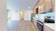 Located at 849 E Magnesium Rd in Spokane, WA, this well-appointed 2-bedroom, 1-bathroom unit offers a thoughtfully designed single-floor layout with modern finishes throughout. The open-concept kitchen and living area serves as the heart of the home, featuring light wood-toned cabinetry, a clean white countertop, stainless steel appliances including a refrigerator and range, and a built-in microwave. Light hardwood-style flooring runs through the main living areas, lending warmth and continuity to the space. A wall-mounted mini-split unit provides efficient climate control. Large sliding glass doors in the living area flood the space with natural light and offer views of the outdoor surroundings. Both bedrooms are carpeted for comfort and feature windows that bring in additional natural light, with one bedroom offering a sliding window with vertical blinds and another with a sliding window framing outdoor views. The hallways connect the living spaces to two closets, providing ample storage. The bathroom is finished with a wood-grain vanity, wide mirror, light countertop, and hardwood-style flooring, maintaining the contemporary aesthetic found throughout the unit. Clean white walls and recessed lighting complete the bright, modern character of this Spokane residence.