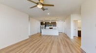 Located at 101 Mirano Way in Nokomis, FL, this well-appointed 2-bedroom, 2-bathroom residence offers a thoughtfully designed single-level floor plan with contemporary finishes throughout. Light-toned luxury vinyl plank flooring flows seamlessly across the entire home, complementing the bright, neutral color palette and creating a clean, cohesive aesthetic.

The open-concept kitchen and living area serves as the heart of the home. The kitchen features a central island with a stainless steel undermount sink and pendant lighting, crisp white quartz countertops, gray shaker-style cabinetry, and a full suite of stainless steel appliances including a refrigerator, range, microwave, and dishwasher. The adjoining living area is generously proportioned, with recessed lighting and a ceiling fan overhead.

Both bedrooms are comfortably sized, with the spacious primary bedroom offering natural light through dual windows and a dedicated ceiling fan. Each bedroom includes its own closet, with wire shelving systems providing organized storage. The primary bathroom is particularly noteworthy, featuring a dual-sink vanity with dark cabinetry, a glass-enclosed walk-in shower, and wood-look flooring. A private balcony extends the living space outdoors, ideal for enjoying the Florida climate.