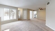 Located at 7301 Bristol Village Drive in Bloomington, Minnesota, this two-story home offers 3 bedrooms and 4 bathrooms across a well-designed layout. The main level is the heart of the home, anchored by a bright kitchen outfitted with white shaker cabinetry, granite countertops, stainless steel appliances, and rich wood-look flooring. A sliding glass door off the kitchen/dining area opens to an outdoor balcony, inviting natural light and exterior views throughout. The living room is a welcoming space featuring plush carpeting, a ceiling fan, and a tile-surround fireplace that serves as the room's focal point, complemented by a large window. The primary bedroom suite includes mirrored closet doors and a dedicated vanity area, combining style and functionality. Additional bedrooms are carpeted and generously sized, each with closet storage. The four bathrooms are finished with clean, neutral tones, wood-look flooring, and tub-shower combinations. The lower level includes an attached garage with built-in storage hooks and utility space. Neutral wall tones and consistent flooring choices throughout create a cohesive, move-in-ready aesthetic.