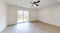 Located at 7952 E 60th Pl in Tulsa, Oklahoma, this thoughtfully designed one-bedroom, one-bathroom unit offers a clean, modern aesthetic throughout. Light-toned luxury vinyl plank flooring flows seamlessly across the entire space, complementing the bright white walls and creating a fresh, cohesive feel.

The open-concept kitchen and living area serves as the heart of the unit. The kitchen is outfitted with white shaker-style cabinetry, a classic subway tile backsplash, gleaming quartz countertops, and a full suite of stainless steel appliances, including a refrigerator, dishwasher, microwave, and a statement stainless range hood over the cooktop. A peninsula provides additional prep and dining space.

The living room is bright and airy, featuring recessed lighting, a ceiling fan, and a sliding glass door that opens to an outdoor green space, filling the room with natural light. The spacious bedroom also includes a ceiling fan, a large window, and direct access to the full bathroom and a dedicated walk-in closet with built-in shelving.

The bathroom features large-format tile surrounds in the tub/shower combo and neutral tile flooring, maintaining the unit's clean, contemporary style throughout.