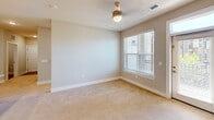Located at 9025 Marengo Way in Charlotte, NC, this well-appointed three-bedroom, two-bathroom residence offers a thoughtfully designed single-floor layout. The kitchen is outfitted with crisp white shaker cabinetry, granite countertops, a classic subway tile backsplash, hardwood-style flooring, and stainless steel appliances including a dishwasher — combining both style and functionality. The bathrooms echo the kitchen's refined aesthetic with matching granite vanity tops, white cabinetry, and brushed nickel fixtures. Each of the three bedrooms features plush wall-to-wall carpeting and windows with blinds that invite natural light, while ceiling fans in the primary and secondary bedrooms enhance comfort. The generously sized primary bedroom includes a walk-in closet with wire shelving systems, offering excellent storage capacity. A dedicated laundry room houses a full-size washer and dryer with additional wire shelving above. The private balcony provides scenic views of the well-maintained community grounds, including landscaped walkways and a resort-style pool. Neutral tones and clean finishes throughout lend the space a bright, move-in-ready feel suited for a variety of lifestyles.