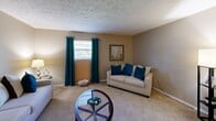 Located at 1825 Liberty Rd in Lexington, KY, this single-floor residence offers a thoughtfully arranged layout comprising a living room, dining room, kitchen, bedroom, bathroom, hallway, and two closets. The carpeted living room provides a comfortable gathering space, featuring textured ceilings, neutral warm-toned walls, and a window dressed with teal curtains that allow natural light to fill the room. Adjacent to the living area, the dedicated dining room includes a ceiling light fixture and decorative wall shelving, creating a practical and inviting space for meals. The kitchen is equipped with dark espresso cabinetry, light countertops, a double-basin sink, and tile flooring, offering ample storage and a functional workspace. The generously sized bedroom features plush carpet, a textured ceiling, and a window with natural light, complemented by a walk-in closet for added storage. The bathroom is finished with tile flooring, a white vanity with under-cabinet storage, a lighted mirror, and a shower-tub combination. Throughout the residence, a consistent neutral color palette and carpet flooring in the main living areas contribute to a cohesive and comfortable ambiance.