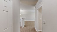 Located at 5750 Forest Park Rd in Dallas, TX, this one-bedroom, one-bathroom unit offers a well-organized single-floor layout designed for comfortable everyday living. Light wood-style flooring runs throughout the main living areas, complemented by neutral wall tones that create a clean, cohesive aesthetic.

The kitchen is a standout feature, equipped with white cabinetry, a suite of white appliances including a range, microwave, and refrigerator, and a peninsula with a double-basin sink. A pendant light above the peninsula adds a focused design touch. Adjacent built-in shelving and a dedicated pantry provide ample storage options.

The living area is bright and airy, featuring a ceiling fan and a sliding glass door that opens to a private balcony with outdoor views of surrounding greenery. The bedroom is generously proportioned, finished with plush carpet and a ceiling fan. A distinctive bay window configuration invites abundant natural light and frames outdoor views, while an additional window further enhances the sense of openness. The bedroom connects conveniently to the rest of the unit.

The bathroom features wood-style flooring, a vanity with light cabinetry and a white countertop, a wall-mounted medicine cabinet, and a full tub-shower combination. A dedicated closet completes the layout, offering practical storage within easy reach of the bedroom.