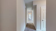 Located at 111 Cheswick Cir in Yorktown, Virginia, this single-story, 3-bedroom, 2-bathroom home offers a thoughtfully designed layout that maximizes functionality and comfort. The interior is finished with neutral tones throughout, creating a clean and versatile living environment.

The kitchen stands out with rich cherry-toned cabinetry, granite countertops, and light tile flooring, lending a warm yet polished feel to the space. It connects seamlessly to a dedicated dining room and is complemented by an adjacent pantry for generous storage. A dedicated laundry area adds everyday convenience.

The living room provides a comfortable gathering space, while the hallway connects the private areas of the home with a carpeted corridor fitted with ceiling-mounted lighting. The three bedrooms are finished with plush carpet, neutral walls, and ceiling fans, with natural light entering through windows dressed with blinds. Each bedroom includes closet access, and the primary bedroom offers direct entry to its own bathroom. With eight closets throughout, storage is abundant.

The two bathrooms are finished with tile flooring and feature tub-shower combinations with brushed nickel fixtures. One bathroom showcases a rich wood vanity with granite countertops, echoing the kitchen's design language. Overall, the home presents a cohesive, move-in-ready interior with practical amenities throughout.