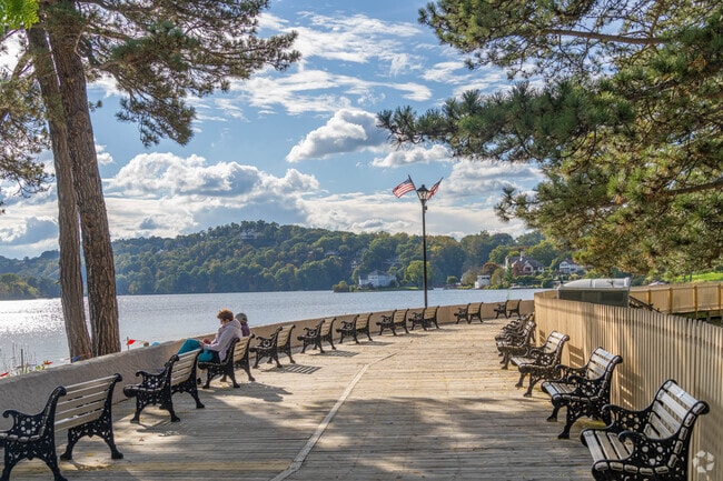Residents relax on benches along Lake Mohawk in Sparta, enjoying the serene views.