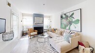 Located at 601 Cabot Ct in Woodbury, New Jersey, this single-floor residence offers a thoughtfully designed open-concept layout with light wood-style flooring flowing throughout the main living areas. The spacious living room is a standout feature, anchored by a classic fireplace framed in a soft blue surround, flanked by windows that invite natural light. A floating white media console provides a sleek, modern focal point, complemented by a generous sectional seating area.

The adjoining dining area transitions seamlessly into the kitchen, which is equipped with white shaker cabinetry, stainless steel appliances including a gas range, refrigerator, and dishwasher, as well as dark countertops and a breakfast bar for casual dining.

The bedrooms are carpeted for comfort, each offering closet storage and windows with blinds and sheer curtains that allow for natural light. The bathroom features a glass-enclosed shower stall, a vanity with a clean white finish, and light wood-style tile flooring.

A dedicated in-unit laundry room houses a full-size washer and dryer, adding everyday convenience. The overall design aesthetic is clean and contemporary, with neutral tones throughout that create a bright, welcoming ambiance across every room.