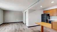 Located at 2084 S Hamilton Rd in Columbus, Ohio, this one-bedroom, two-bathroom unit offers a thoughtfully organized single-floor layout that maximizes every square foot. Light gray walls and wood-look vinyl plank flooring run throughout, creating a clean, cohesive aesthetic.

The open-concept kitchen and dining area serves as a functional hub of the unit. The kitchen is equipped with warm honey-toned wood cabinetry, light marble-style countertops, a full suite of black appliances including a refrigerator, dishwasher, electric range, and over-the-range microwave, as well as a built-in plate rack for added storage. A dining table fits neatly adjacent to the kitchen, making efficient use of the shared space.

The living room offers an open, unobstructed area with a textured ceiling, recessed lighting, and a sliding barn-style door that leads to the bedroom — adding a modern, space-conscious design touch. Two closets provide ample storage throughout the unit.

The primary bedroom is a comfortable, well-proportioned retreat. One full bathroom features a clean white tub-shower combo with chrome fixtures, while a second bathroom showcases a wide vanity with rich wood cabinetry, a granite-style countertop, and a large wall mirror with overhead lighting. Both bathrooms continue the vinyl plank flooring. A utility room rounds out the layout, adding practical functionality to the space.