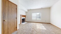 Located at 4551 Durrow Dr in Columbus, Ohio, this two-floor home offers a well-organized and functional layout spread across two levels. The main living area is generously sized, featuring plush wall-to-wall carpeting, a textured ceiling, and a classic wood-mantled fireplace with a tiled surround that serves as a natural focal point. Natural light filters in through windows dressed with horizontal blinds, brightening the neutral-toned interior throughout.

The kitchen is designed with practicality in mind, featuring warm wood cabinetry, a white appliance suite including a range and refrigerator, and a raised breakfast bar peninsula that opens to the adjacent living and dining areas. Tile flooring in the kitchen and connecting spaces provides a durable and easy-to-maintain surface.

The bedrooms are carpeted and well-lit, each with windows that allow ample natural light. The bathrooms are outfitted with tile flooring, wood-toned vanity cabinetry with generous counter space, and a full tub-shower combination. A dedicated laundry room includes washer and dryer hookups, overhead wire shelving, and tile flooring for added convenience. The layout across both floors provides clear separation between living and private spaces, making this a practical and comfortable home.