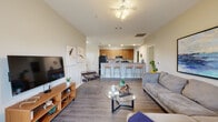 Located in San Antonio, TX (78249), this single-floor residence offers a thoughtfully designed layout with an open-concept living and dining area that flows seamlessly into the kitchen. The living space features wood-look flooring, vaulted ceilings, a ceiling fan, and generous wall space for artwork, creating a bright and welcoming atmosphere. The kitchen is equipped with warm-toned wood cabinetry, black appliances including a full-size refrigerator and electric range, ample counter space, and a breakfast bar with seating — ideal for casual dining. A separate dining nook with windows provides additional natural light. The residence includes multiple bedrooms, each carpeted and fitted with windows dressed in curtains and blinds. One bedroom features a built-in desk area, while another offers a more spacious layout with decorative wall accents. The bathroom is clean and functional, complete with a full tub-shower combination, wood-toned vanity cabinetry, and hardwood-style flooring. An in-unit laundry area houses a full-size washer and dryer with built-in shelving above for storage. Throughout, neutral wall tones and consistent flooring choices create a cohesive, modern aesthetic well-suited for comfortable everyday living.