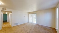 Located at 1900 Laurel Rd in Lindenwold, NJ, this single-floor unit offers a clean, functional layout across several well-defined living spaces. The living room is a bright, open area finished with wall-to-wall carpeting and features a sliding glass door dressed with vertical blinds, providing direct access to an outdoor area and allowing natural light to fill the space. Tall, narrow windows in a secondary living area further enhance the sense of openness and provide views of the surrounding greenery.

The kitchen is efficiently designed with warm honey-toned cabinetry, gray laminate countertops, a stainless single-basin sink, and light tile flooring. It is equipped with a full suite of white appliances, including a gas range, dishwasher, and refrigerator, along with a decorative tile accent backsplash adding a touch of character.

The bedrooms are carpeted and feature ample closet space, including a mirrored sliding-door closet in one room and a walk-in closet in another. Each bedroom is connected to the broader layout with convenient hallway access.

The bathroom is finished with light tile flooring, a wooden vanity with a white countertop, a wall-mounted mirror, and a full shower-tub combination. Overall, the unit presents a neutral, move-in-ready aesthetic throughout.