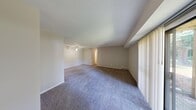 Located at 5410 Maple Park Dr in Flint, Michigan, this single-floor, 2-bedroom, 2-bathroom home offers a practical and comfortable layout. The open living area is carpeted and bathed in natural light through a large sliding glass door fitted with vertical blinds, which provides a pleasant outdoor view and serves as a seamless connection to the exterior. A ceiling fan adds to the comfort of the living space. The kitchen is well-appointed with warm wood-toned cabinetry, light countertops, wood-look tile flooring, and white appliances including a refrigerator and dishwasher. A dedicated in-unit laundry room houses a full-sized washer and dryer alongside a water heater. Both bedrooms are carpeted and receive natural light through windows with vertical blinds, offering a calm and functional retreat. The primary bedroom is generously sized with ample room for furnishings. The two bathrooms feature wood-look tile flooring, light countertops, extended vanities with under-sink storage, and well-lit mirrors. A textured ceiling runs throughout the home, and neutral wall tones create a cohesive, move-in-ready aesthetic. A hallway and closet provide additional storage and circulation throughout the space.