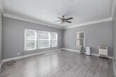 Located at 681 Shatto Pl in the heart of Los Angeles, CA, this one-bedroom, one-bathroom unit offers a well-organized single-floor layout designed for comfortable urban living. Light wood-style flooring flows seamlessly throughout the space, tying each room together with a clean, cohesive aesthetic.

The generously sized bedroom is one of the most notable features of the unit, offering ample room for furnishings, multiple windows with blinds for natural light control, and a ceiling fan with a light fixture. Crown molding along the ceiling adds a classic architectural touch.

The kitchen is thoughtfully appointed with white shaker-style cabinetry, dark countertops, a white subway tile backsplash, and a full suite of stainless steel appliances including a gas range with a wall-mounted hood, dishwasher, and refrigerator. A window above the sink allows natural light to brighten the space.

A central hallway connects the rooms efficiently and provides access to two closets for ample storage. The bathroom features a distinctive hexagonal-patterned tile floor, a wall-mounted vanity, a mirrored medicine cabinet, built-in open shelving, and a subway-tiled shower area. The unit's soft gray wall palette throughout creates a calm, modern ambiance.