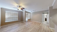 Located at 10498 Fountain Lake Drive in Stafford, TX, this single-story, 3-bedroom, 2-bathroom home offers a clean and functional layout with modern finishes. The open living area features light wood-style flooring, crown molding, a ceiling fan with integrated lighting, and track lighting, all complemented by warm neutral-toned walls. Multiple windows with white blinds allow ample natural light to fill the space.

The kitchen is well-equipped with rich dark-walnut cabinetry, light granite-style countertops, black appliances including a range, microwave, and refrigerator, and a stainless steel double sink. A peninsula counter provides additional workspace and a natural transition to the living area.

The bedrooms are carpeted and include ceiling fans and window treatments, offering a comfortable, quiet atmosphere. The primary bedroom is generously sized and includes access to a spacious walk-in closet outfitted with wire shelving systems for organized storage.

The primary bathroom features an extended dark-wood vanity with a white countertop, a large framed mirror, and a well-lit vanity light bar, all set above the same light wood-style flooring found throughout the main living areas. An in-unit laundry area accommodates a full-size washer and dryer, adding everyday convenience. The home offers a practical and comfortable living environment with consistent, cohesive design details throughout.