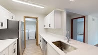 Located at 4695 Aldun Ridge Ave NW in Comstock Park, Michigan, this single-floor, 2-bedroom, 2-bathroom home offers a clean, functional layout with modern finishes. The open kitchen is a standout feature, showcasing white shaker cabinetry with matte black hardware, light quartz countertops, a stainless steel undermount sink, and stainless steel appliances including a refrigerator, range, and dishwasher. The kitchen flows seamlessly into the living room, which is finished with warm-toned luxury vinyl plank flooring and features a sliding glass door that fills the space with natural light and provides direct access to a patio with outdoor views. Both bedrooms are carpeted and offer a quiet, comfortable retreat, with the primary bedroom providing generous proportions and a well-sized closet. The secondary bedroom includes a built-in sliding wood closet. Each bathroom features white vanity cabinetry, quartz countertops, tile flooring, and a tub-shower combination. A dedicated in-unit laundry room with a full-size washer and dryer adds everyday convenience. Light-toned walls, wood-trimmed doorways, and consistent finishes throughout lend the home a cohesive and well-maintained character.