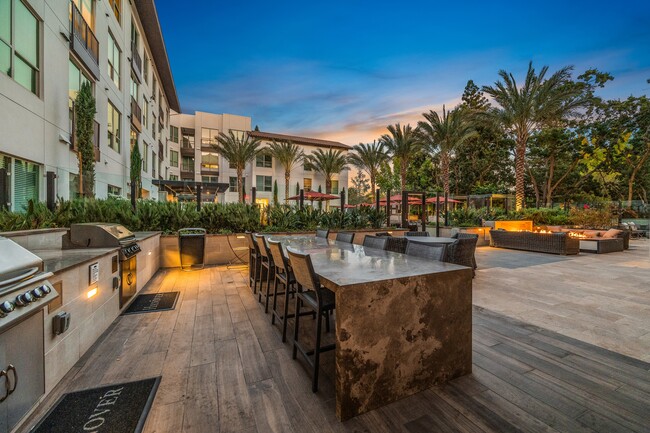 Expansive social courtyard featuring bocce ball and ping pong, fire pits surrounded by intimate seating areas, and grills with open-air dining areas - Hanover Walnut Creek