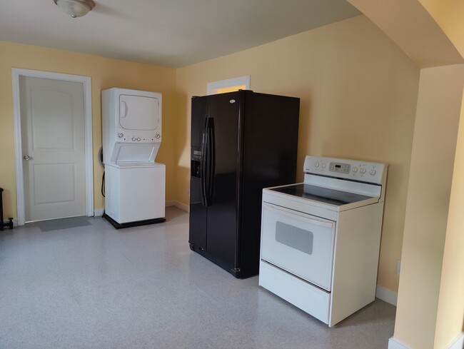 Appliances include stackable washer and dryer, refrigerator, and stove/oven. - 232 East Ave