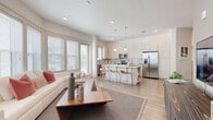 Located at 340 Central Ave in downtown Sarasota, Florida, this single-floor residence offers a thoughtfully designed open-concept layout with modern finishes throughout. The living area is bright and welcoming, featuring large windows that invite abundant natural light and light-toned hardwood flooring that flows seamlessly into the adjacent spaces. A stylish kitchen anchors the common area, equipped with stainless steel appliances, a subway tile backsplash, light wood cabinetry, quartz countertops, and a central island with bar seating — ideal for both cooking and entertaining. A dining nook connects naturally to the living space, creating an effortless flow for daily living. The bedrooms offer plush carpeting, generous windows with garden views, and a calm, restful ambiance. The primary suite includes a spacious walk-in closet with custom shelving. Two bathrooms are finished with large-format tile flooring, light wood floating vanities, and quartz countertops; one features a soaking tub with shower combo, while the other offers a glass-enclosed shower. Recessed lighting and a neutral color palette throughout contribute to the residence's clean, contemporary aesthetic.