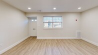 Located at 251 S Olds Blvd in Fairless Hills, PA, this thoughtfully updated two-bedroom, one-bathroom single-floor home offers a clean, modern aesthetic throughout. Light wood-style luxury vinyl flooring runs continuously across the entire space, creating a cohesive and bright atmosphere.

The open-concept kitchen and living area serves as the heart of the home. The kitchen is well-appointed with dark shaker-style cabinetry, white quartz countertops, a subway tile backsplash, a matte black faucet, and a full suite of stainless steel appliances including a gas range, microwave, dishwasher, and refrigerator. A peninsula provides additional prep and dining space. Recessed lighting and large windows allow natural light to fill the living area, which also features a paneled front door entry.

The spacious primary bedroom includes a double-door closet with matte black hardware and a window with neighborhood views. The second bedroom is bright and well-sized with its own closet. The bathroom features a navy blue vanity with white countertop, a rounded rectangular mirror with black accents, and tile flooring. A dedicated laundry room houses a stacked LG washer and dryer unit. The space is completed by a utility/electrical area and clean white trim throughout.