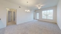 Located at 34011 Harvard Ave in Millsboro, Delaware, this single-floor home offers a well-designed layout with a clean, neutral aesthetic throughout. The open living and dining area is bright and spacious, featuring soft carpeting, a ceiling fan, an elegant chandelier, and a glass-paned door that welcomes natural light. The kitchen is outfitted with rich, dark wood cabinetry, granite-style countertops, wood-look vinyl flooring, and a full suite of black appliances including a refrigerator, range, and built-in microwave. Multiple bedrooms are carpeted and fitted with ceiling fans; one features a generous walk-in closet with built-in rod storage and elevated ceilings, while others include double-door closets and windows that bring in natural light. Two bathrooms share a consistent design with dark wood vanities, white countertops, and wood-look vinyl flooring — one includes a tub-shower combination, and the other a sliding glass-door shower. A dedicated laundry area accommodates a full-size washer and dryer with overhead shelving for added storage. Throughout the home, a consistent palette of white walls, light carpet, and warm wood-tone flooring creates a cohesive and welcoming atmosphere.