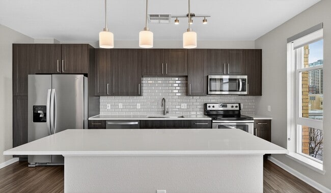 Enjoy sleek finishes and thoughtful details in your modern kitchen. - 20th Street Station