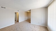 This 700 square foot apartment in Memphis, TN offers a practical living space with two bedrooms and one bathroom. The single-story layout maximizes efficiency, featuring a primary bedroom of 130 square feet. The interior showcases a neutral color palette with off-white walls throughout, creating a blank canvas for personalization. Both bedrooms are carpeted in a light brown tone, providing warmth and comfort underfoot. The kitchen, while compact, is well-equipped with white cabinetry, wood countertops, and essential appliances including a refrigerator and dishwasher. A window in the kitchen door allows natural light to penetrate the space. The apartment includes two closets for storage and a hallway connecting the rooms. Windows in the bedrooms offer views of the surrounding greenery, enhancing the living experience with natural light and outdoor vistas. The overall design prioritizes functionality in a modest space, ideal for those seeking a no-frills living arrangement in an urban setting.