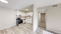 Located at 320 Spruce St in Spartanburg, SC, this single-floor, one-bedroom, one-bathroom residence offers a functional and thoughtfully designed layout. Light-toned luxury vinyl plank flooring runs throughout the entire space, providing a cohesive and clean aesthetic. The kitchen is a standout feature, equipped with stainless steel appliances including an electric range and refrigerator, white shaker-style cabinetry, light countertops, and an under-cabinet range hood. A single-basin sink sits beneath overhead cabinetry, maximizing storage efficiency. The kitchen flows naturally into a hallway connecting the remaining rooms. The living room is generously proportioned, bathed in natural light through a large window with horizontal blinds that frame outdoor greenery. Neutral warm-beige walls and a textured ceiling complement the airy feel. The bedroom offers a comfortable footprint, also featuring a natural light-filled window, a sliding-door closet with built-in shelving, and the same durable vinyl plank flooring. The bathroom includes a full tub-shower combination with a built-in grab bar and a clean, bright finish. Overall, the space presents a fresh, modern atmosphere suited for comfortable everyday living.
