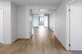 This well-designed unit at 3385 Dundas St W in Toronto's vibrant Junction neighbourhood offers four bedrooms and two full bathrooms across a single floor. The interior features a consistent modern aesthetic, highlighted by light-toned laminate wood flooring and crisp white walls throughout, creating a bright and cohesive living environment.

The kitchen is designed with functionality in mind, featuring white upper cabinetry, light stone countertops, stainless steel appliances including a refrigerator and dishwasher, and light tile flooring. The layout maximizes the available counter and storage space efficiently.

Each of the four bedrooms maintains the same clean, neutral design language, with light wood flooring, white walls, and double-door closets providing practical storage. Select bedrooms benefit from windows that introduce natural light and outdoor views of the surrounding neighbourhood.

Both bathrooms are finished in a consistent modern style, each featuring a full soaker tub with tiled surround, a white vanity with an undermount sink and light countertop, a large mirror with overhead lighting, and tile flooring. The entrance provides a functional transition into the unit. Overall, the space presents a clean, move-in-ready environment suited for shared or family living.
