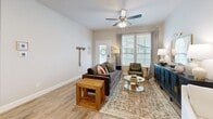 This well-appointed one-bedroom, one-bathroom single-story unit in Conroe, Texas offers a thoughtfully designed layout that maximizes functionality and comfort. Wood-look plank flooring runs throughout, providing a warm, cohesive aesthetic across every room.

The living room is bright and welcoming, featuring large windows that allow generous natural light, a ceiling fan, and neutral-toned walls that create a versatile backdrop. The kitchen is equipped with white shaker-style cabinetry, light quartz countertops, a full suite of stainless steel appliances—including a side-by-side refrigerator with ice maker, range, and built-in microwave—and a breakfast bar ideal for casual dining.

The primary bedroom is a comfortable retreat highlighted by a bold botanical accent wall, large windows with natural light, and a ceiling fan. A spacious walk-in closet offers extensive built-in shelving and hanging rods for ample storage. A dedicated office provides a quiet workspace with its own window and ceiling fan. The full bathroom features a single-sink vanity with gray cabinetry, white countertop, a large mirror, and a glass-enclosed walk-in shower. Additional conveniences include in-unit laundry, a hallway with access to a second closet, and a private patio.