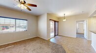 Located at 2606 Thomas Drive in El Centro, California, this single-story, 3-bedroom, 2-bathroom home offers a practical and comfortable layout throughout. The combined kitchen and living area forms the heart of the home, with the living room featuring plush carpeting, a ceiling fan with light fixture, a pendant light, and a sliding glass door with vertical blinds that opens to an outdoor area, allowing natural light to fill the space. The galley-style kitchen is well-equipped with rich wooden cabinetry, dark granite countertops, recessed lighting, tile flooring, and black appliances including a gas range, microwave, and refrigerator. The three bedrooms are carpeted and each include a ceiling fan, with the primary bedroom offering direct access to the outdoors via a sliding glass door. The primary bedroom also features a dedicated walk-in closet with built-in shelving and hanging rods. The two bathrooms are finished with tile flooring and wooden vanities with light countertops. The primary bathroom includes a soaking tub, a shower-tub combo, and a dual-sink vanity with wall-mounted lighting. A carpeted hallway connects the bedrooms and bathrooms, creating a cohesive and navigable floor plan throughout this inviting home.