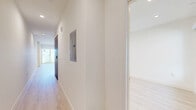 Located at 1339 Tamarind Ave, Unit 402 in the heart of Hollywood, Los Angeles, this contemporary three-bedroom, two-bathroom residence offers a thoughtfully designed single-level layout. Light-toned luxury vinyl plank flooring runs seamlessly throughout, lending a bright, cohesive feel to every room.

The open kitchen is a standout feature, showcasing flat-front wood-grain cabinetry, a white tile backsplash, and a full suite of stainless steel appliances including a gas range, built-in microwave, dishwasher, and a full-size side-by-side refrigerator. Recessed lighting illuminates the space efficiently.

The generously sized primary bedroom includes direct access to a private en-suite bathroom and a mirrored sliding closet. Its en-suite features a large glass-enclosed walk-in shower with floor-to-ceiling tile, a wood-vanity with white countertop, and clean modern fixtures. The two additional bedrooms are well-proportioned and filled with natural light from large windows offering city views. A second full bathroom mirrors the same modern aesthetic with a tiled shower and warm wood vanity.

Throughout the unit, crisp white walls, recessed lighting, and a neutral palette create a clean, contemporary ambiance well-suited to urban living in one of Los Angeles' most vibrant neighborhoods.