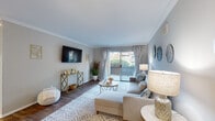 Located at 3901 Mesa Dr in Oceanside, California, this single-floor residence offers a welcoming coastal aesthetic throughout. The open living area is anchored by crown molding, wood-style flooring, and a sliding glass door that floods the space with natural light and provides direct access to a private patio with garden views. The layout flows seamlessly from the living room into a dedicated dining area, creating a comfortable and functional common space.

The kitchen is well-appointed with white shaker cabinetry, light countertops, and a full suite of stainless steel appliances, including a refrigerator, range, microwave, and dishwasher. Wood-style flooring continues throughout the kitchen, adding warmth and cohesion to the space.

Multiple bedrooms provide comfortable retreats, each featuring plush carpeting, natural light from windows with sheer curtains, and ceiling fans for year-round comfort. The bedrooms carry through the home's coastal theme with soft, neutral tones.

Two full bathrooms are finished with white cabinetry, light stone-style countertops, large mirrors, and tub-shower combinations. Each bathroom is clean and efficiently designed. The overall ambiance of the home is light, airy, and cohesive, with a consistent coastal theme that ties each room together in a relaxed yet polished style.