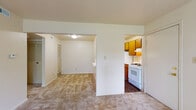 Located at 3110 S Jefferson Ave in Springfield, Missouri, this single-floor unit offers a practical and well-organized layout designed for comfortable everyday living. The living area is finished with neutral-toned wall-to-wall carpeting and connects seamlessly to the adjacent spaces, creating an open and accessible flow throughout. A sliding glass door fills the living space with natural light and provides direct access to an outdoor balcony area, offering a pleasant view of the surrounding greenery. The kitchen is efficiently laid out with warm wood-toned cabinetry, white gas range and oven, a full-size refrigerator, and durable wood-look flooring. A louvered pantry door adds functional storage within the kitchen. The bedroom is a quiet, carpeted space illuminated by a window fitted with blinds for privacy and light control. The bathroom is clean and straightforward, featuring a single-sink vanity with wood cabinetry, a full tub and shower combination with tiled surround, and wood-look flooring that coordinates with the kitchen. Throughout the unit, the neutral color palette and simple finishes create a cohesive, move-in ready environment suited for a range of living arrangements.