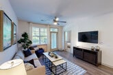 Located at 15711 Clems Creek Ln in Charlotte, NC, this single-floor, 2-bedroom, 2-bathroom residence offers a thoughtfully designed layout with modern finishes and comfortable living spaces. The open-concept kitchen is a standout feature, equipped with stainless steel appliances, rich dark cabinetry, granite countertops, a large center island with an undermount sink, and stylish pendant lighting — all flowing seamlessly into the living and dining areas. The living room is bright and inviting, with large windows that fill the space with natural light, a ceiling fan, and direct access to a private balcony overlooking a community pool and lush tree-lined surroundings. The primary bedroom is a comfortable retreat featuring plush carpeting, a bold accent wall, a ceiling fan, and a walk-in closet with wire shelving. The second bedroom offers similar comfort with neutral tones and ample storage. Both bathrooms are finished with granite-topped vanities and clean white tile, with the full bath featuring a soaking tub and tiled surround. Hardwood-style flooring runs throughout the main living areas, complementing the clean, contemporary aesthetic. A connecting hallway provides easy access to all rooms, making for a practical and livable floor plan.