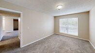 Located at 400 Northport Dr in Cabot, Arkansas, this single-story, three-bedroom, two-bathroom home offers a functional and comfortable layout. The interior is finished with warm neutral tones throughout, creating a cohesive and inviting atmosphere.

Each of the three bedrooms features plush wall-to-wall carpeting and large windows with blinds that allow ample natural light while maintaining privacy. The spacious primary bedroom includes a dedicated closet, providing convenient storage. The additional bedrooms are well-proportioned and similarly finished, making them adaptable for various uses.

Both bathrooms are identically appointed, each featuring a full tub-shower combination, a toilet, wood-look flooring, and wood-trimmed overhead cabinetry that offers useful storage space above the fixtures.

A dedicated laundry room houses a full-size washer and dryer with an overhead wire shelving rack, adding practical utility to the home. Two hallways connect the rooms efficiently, contributing to a smooth flow throughout the single-floor layout.

Textured ceilings are consistent across the home, and each room is equipped with ceiling-mounted light fixtures and HVAC vents, ensuring year-round comfort. Clean white trim and baseboards complement the neutral wall colors, giving the home a tidy, well-maintained appearance throughout.