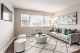 This single-floor residence at 23–43 Colfax St in Toms River, NJ offers a thoughtfully laid-out living space with a neutral, contemporary aesthetic throughout. The living room serves as a welcoming focal point, featuring rich dark hardwood flooring, large windows that draw in natural light, and a wall-unit air conditioner. The open, airy feel is reinforced by the warm taupe tones carried consistently across every room.

The dining area adjoins the living space and continues the hardwood flooring, highlighted by a ceiling fan with integrated lighting. A closet with bi-fold doors adds practical storage nearby.

The kitchen is well-equipped with stainless steel appliances, including a smooth-top electric range, over-range microwave, and dishwasher. Granite-style countertops, white subway tile backsplash, and a window overlooking the outdoors complete the functional yet attractive space. Baseboard heating is present throughout.

The primary bedroom offers carpeted flooring, multiple closets, and a sliding glass door providing outdoor access and natural light. A second bedroom, also carpeted, includes a window and comfortable proportions. The bathroom features a white vanity with brushed nickel fixtures, a mirrored medicine cabinet, and clean, minimal finishes.