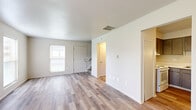 Located at 764 Kelford Pl in Trotwood, Ohio, this two-story home offers a practical and comfortable layout across two well-proportioned floors. The main level features a bright, open living room finished with light-toned luxury vinyl plank flooring that runs throughout, complemented by multiple windows that allow natural light to fill the space. The kitchen is equipped with dark upper and lower cabinetry, a double-basin sink, white appliances including a refrigerator and dishwasher, and matching LVP flooring, providing a functional workspace. A staircase connects the main level to the upper floor, where both bedrooms are located. The bedrooms feature plush carpeting underfoot, ample wall space, and generous closet storage. The primary bedroom is notably spacious and includes a large walk-in closet outfitted with built-in shelving and a hanging rod for organized storage. Both bathrooms are clean and functional, with one featuring a full tub-shower combination, a single-sink vanity with a speckled countertop, and LVP flooring. A hallway connects the upper-level rooms, enhancing the overall flow of the home. The layout is efficient, making thoughtful use of every square foot across both floors.
