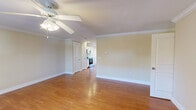 Located at 833 Old Greenville Hwy in Clemson, SC, this well-appointed single-story, 3-bedroom, 2-bathroom home offers a comfortable and functional layout. The open living room features warm hardwood flooring, crown molding, and a ceiling fan, creating a bright and inviting atmosphere with natural light streaming through large windows. The kitchen is a standout space, outfitted with stainless steel appliances including a refrigerator, range, microwave, and dishwasher, complemented by white cabinetry, granite-style countertops, recessed lighting, and hardwood floors that continue throughout. French doors provide additional light and outdoor access directly from the kitchen area. The generously sized primary bedroom features plush carpeting, a ceiling fan, a dedicated closet, and direct access to a private ensuite bathroom. The additional bedrooms are also carpeted and offer ample closet space with ceiling fans. Both bathrooms are finished with clean white tile surrounds on the tub-shower combinations and chrome fixtures. Crown molding and consistent neutral tones throughout lend the home a cohesive, polished feel, making it a practical and comfortable residence in the heart of Clemson.