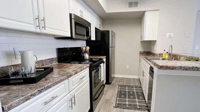 Our galley-style kitchens offer abundant cabinet space. - Indigo Isles