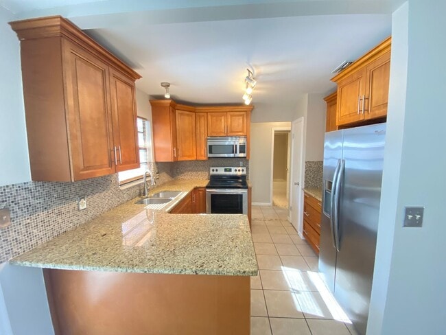 Building Photo - 2/2 home with garage - tile on inside with screened rear porch!